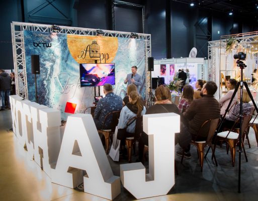 Mężczyzna prowadzi prezentację dla publiczności na targach.